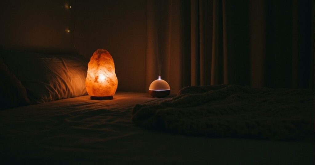 Healing sleep environment with blackout curtains and diffuser for post-illness recovery